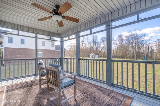 sunroom featuring a ceiling fan and a healthy amount of sunlight