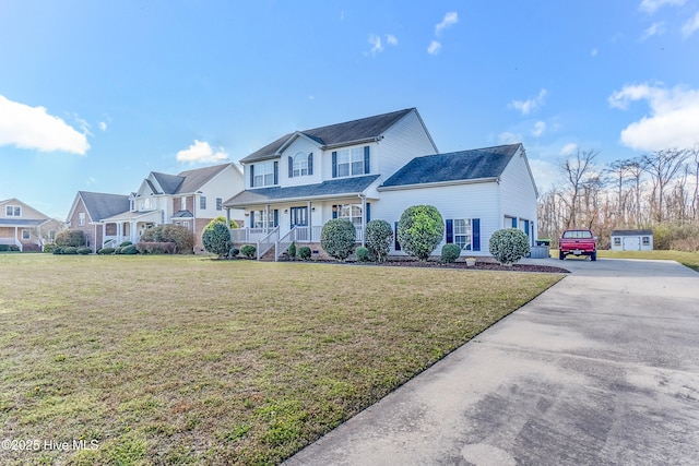 view of front of house with concrete driveway, a front yard, a porch, and a residential view