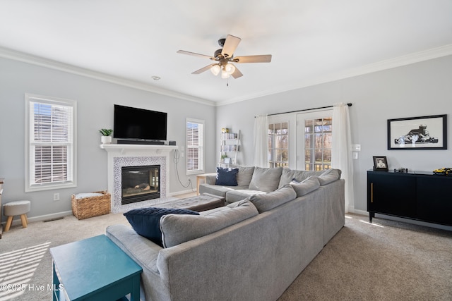 living room featuring ornamental molding, ceiling fan, and carpet