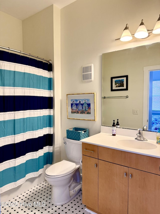bathroom with toilet, vanity, a shower with shower curtain, and tile patterned flooring