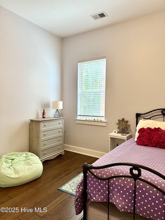 bedroom featuring wood finished floors and baseboards