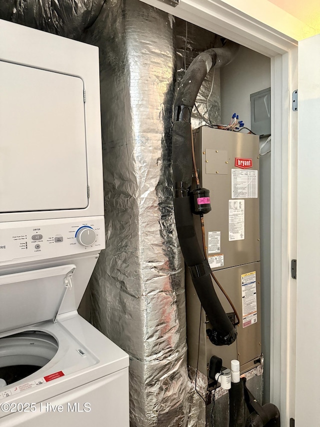 laundry area with stacked washer / drying machine