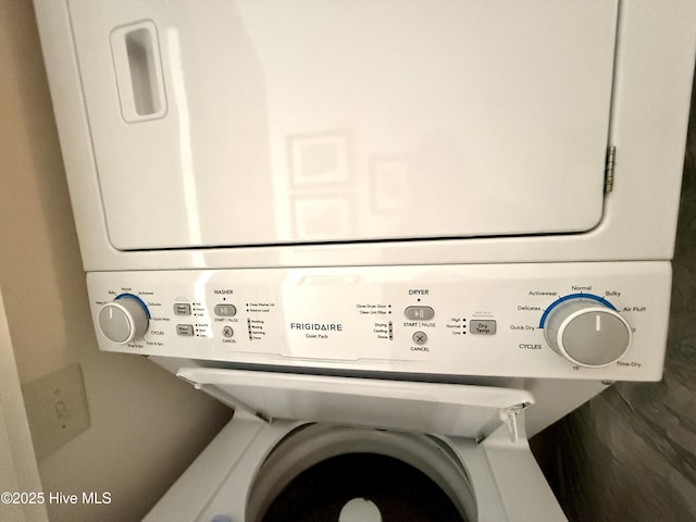 laundry room with stacked washer / drying machine