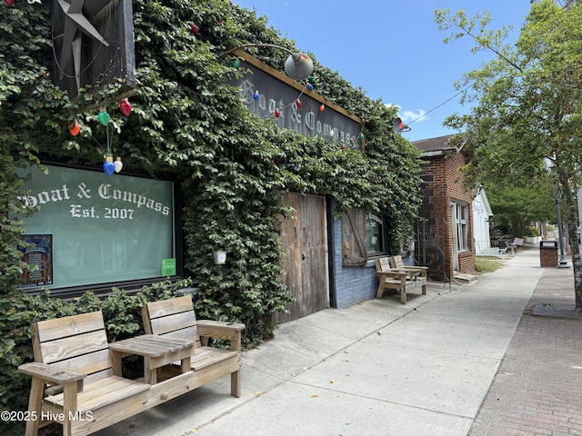 exterior space with brick siding and a patio