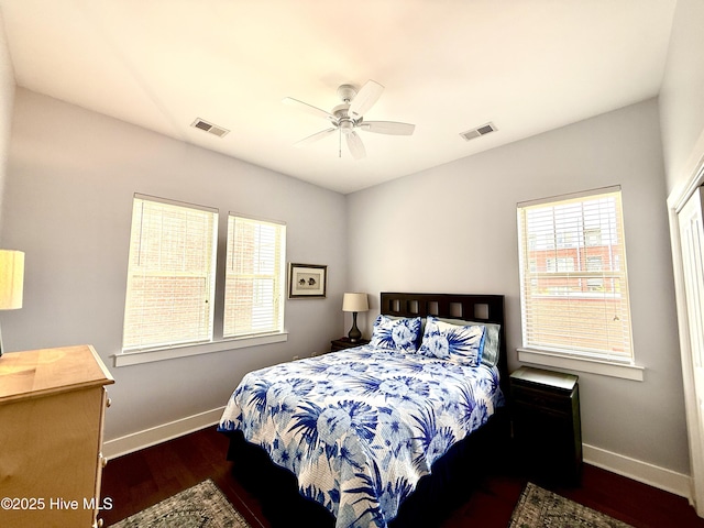 bedroom with baseboards, wood finished floors, and a ceiling fan