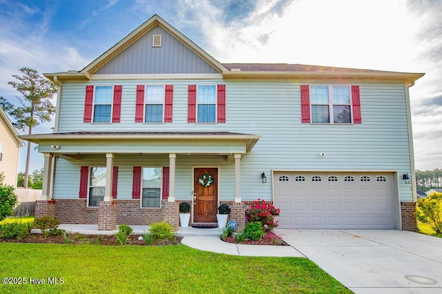 view of front of house with brick siding, a garage, driveway, a front lawn, and covered porch
