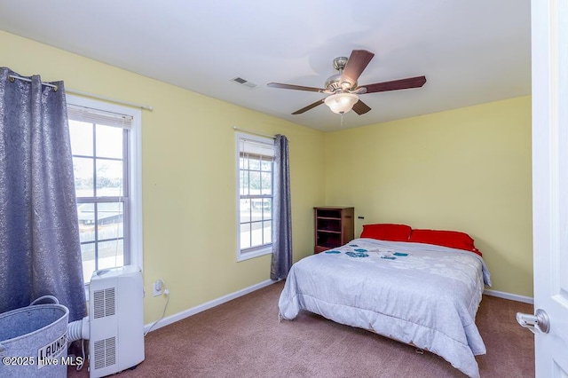 bedroom featuring carpet floors, multiple windows, and baseboards