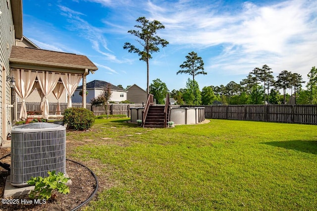 view of yard with central AC unit and stairway