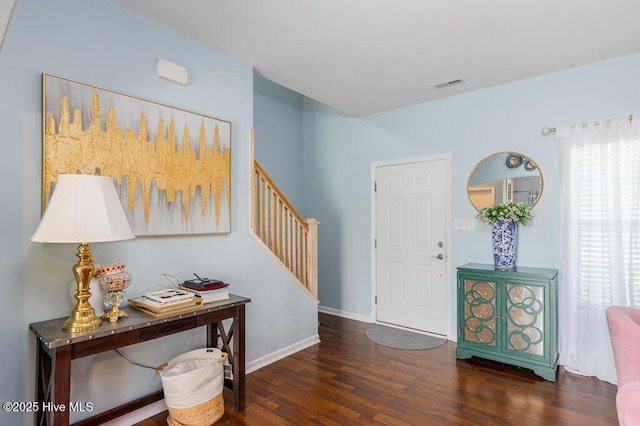 foyer featuring stairway, wood finished floors, plenty of natural light, and baseboards