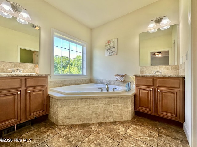 101 Pete Bunch Ln, Hobbsville, NC 27946 - bathroom featuring two vanities, a garden tub, and backsplash
