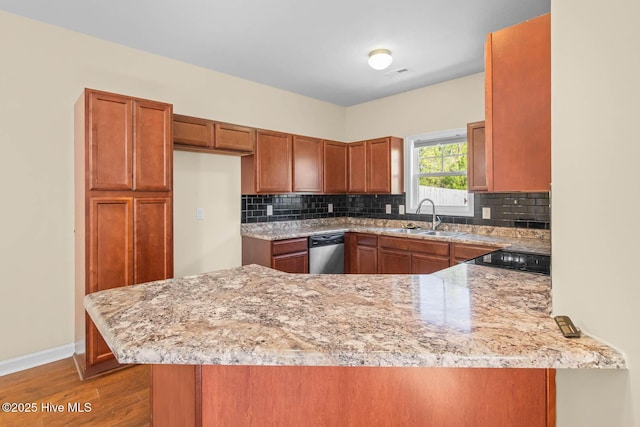 323 Frisco Way, Holly Ridge, NC 28445 - kitchen featuring a sink, stainless steel dishwasher, a peninsula, brown cabinetry, and wood finished floors