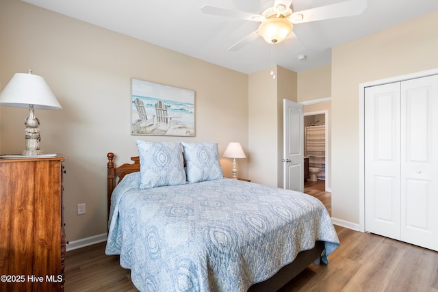 bedroom featuring wood finished floors, a closet, baseboards, and ceiling fan