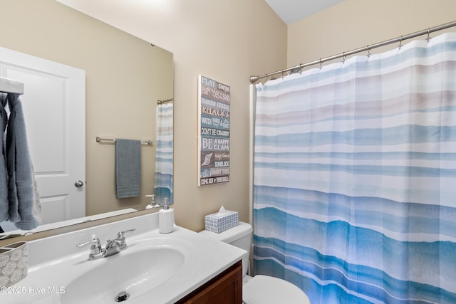 bathroom featuring vanity, toilet, and a shower with shower curtain