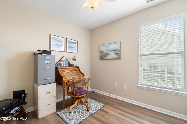 home office featuring ceiling fan, light wood-style floors, and baseboards