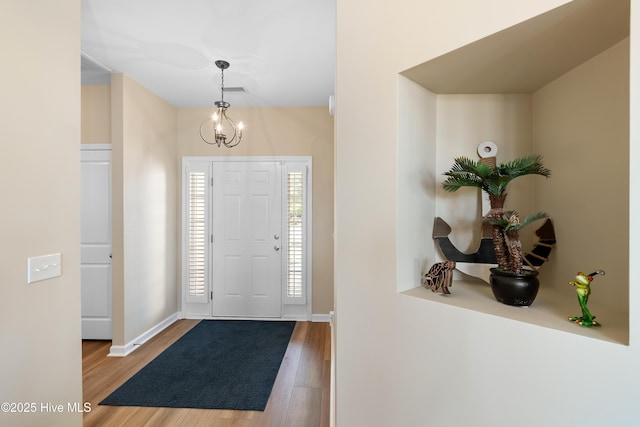 entrance foyer with wood finished floors and baseboards