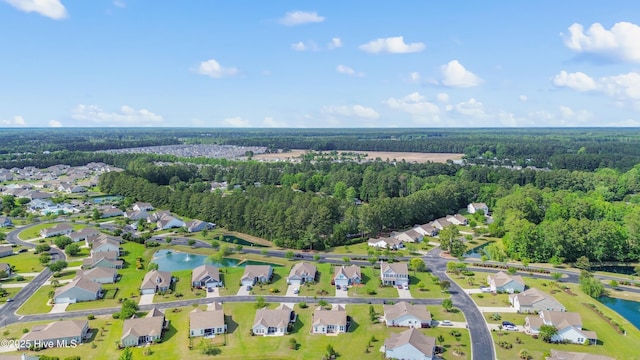 aerial overview of property's location with nearby suburban area, a heavily wooded area, and a large body of water