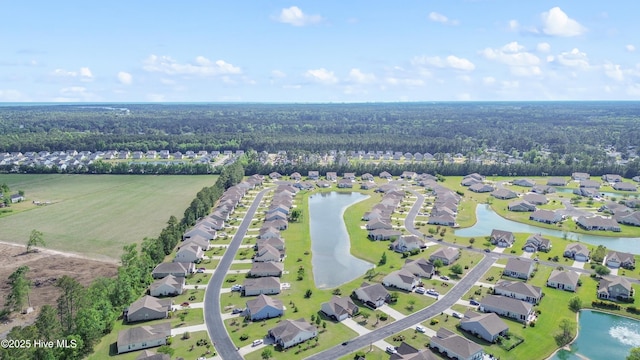 aerial overview of property's location featuring a heavily wooded area, nearby suburban area, and a nearby body of water