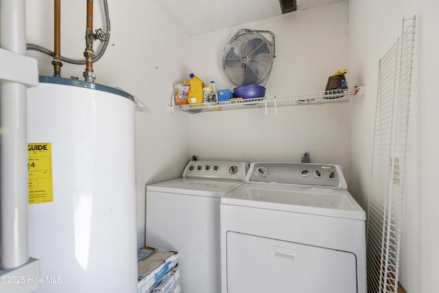 laundry area featuring washing machine and clothes dryer, water heater, laundry area, and visible vents