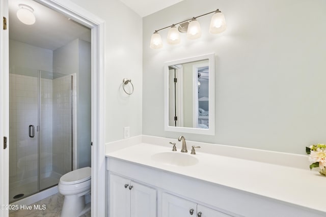 full bathroom with vanity, toilet, and a shower stall