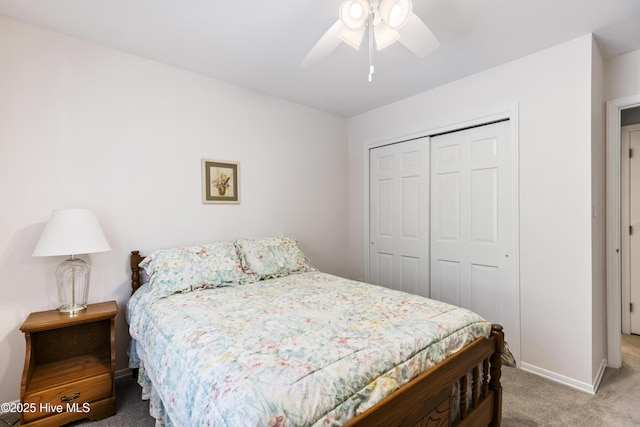 carpeted bedroom featuring baseboards, a closet, and a ceiling fan