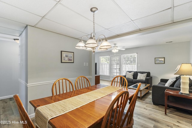 dining room featuring an inviting chandelier, light wood-style floors, visible vents, and a paneled ceiling