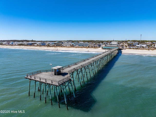 dock area with view of water and beach and a pier