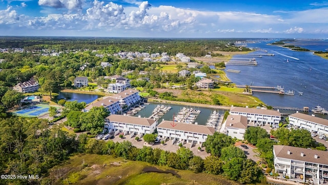 drone / aerial view of a nearby body of water and a marina