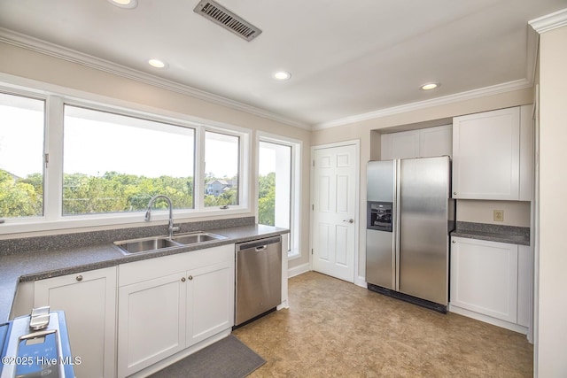 kitchen featuring stainless steel appliances, a sink, dark countertops, light floors, and ornamental molding