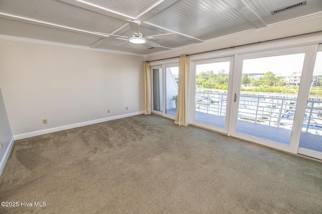 carpeted empty room with baseboards, a ceiling fan, and ornamental molding