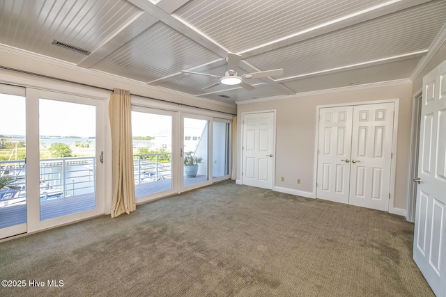 unfurnished bedroom featuring access to outside, carpet, crown molding, coffered ceiling, and two closets