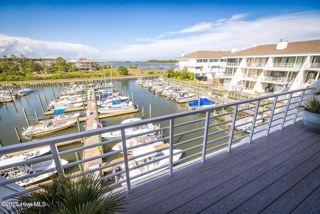 wooden terrace featuring a water view and view of marina