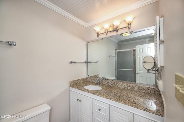 full bathroom featuring toilet, crown molding, a stall shower, and vanity