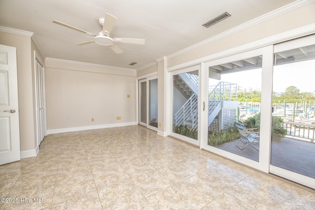 spare room with ornamental molding, a ceiling fan, and baseboards
