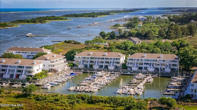 aerial view of a nearby body of water, a marina, and apartment complex