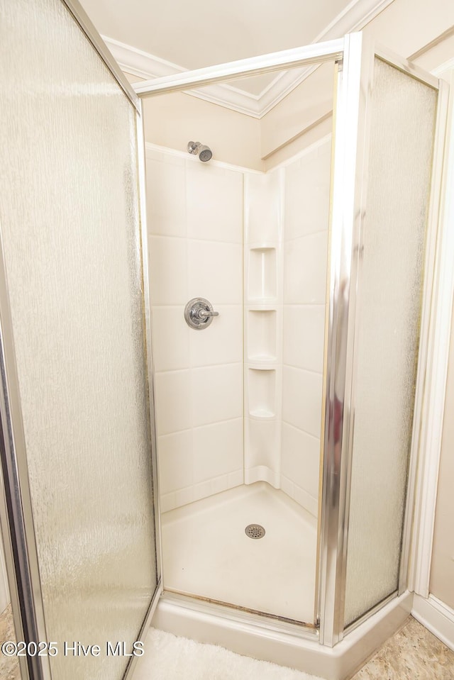 bathroom featuring a stall shower and ornamental molding