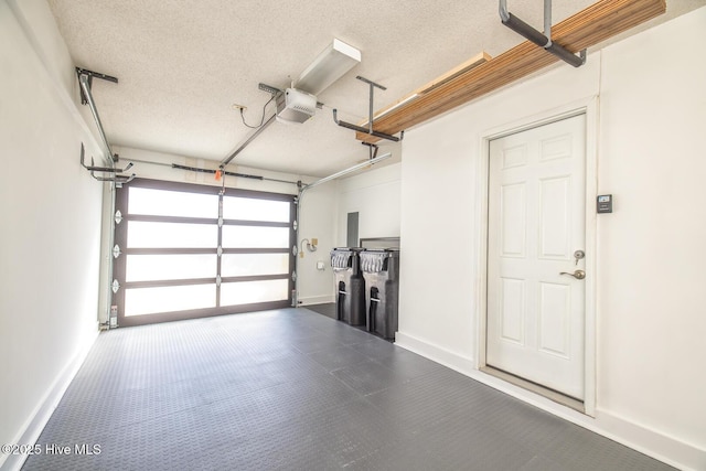 garage featuring a garage door opener and baseboards