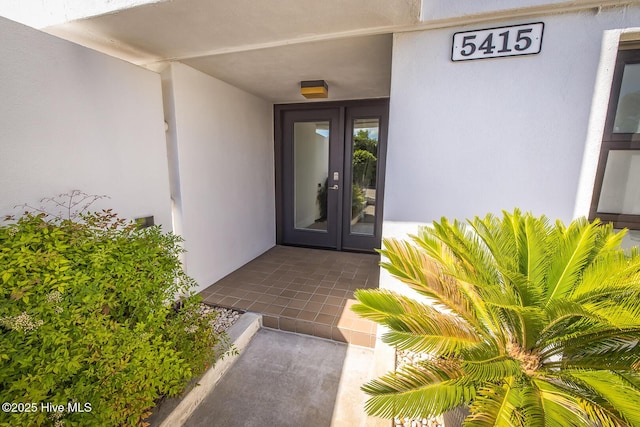 property entrance featuring french doors and stucco siding