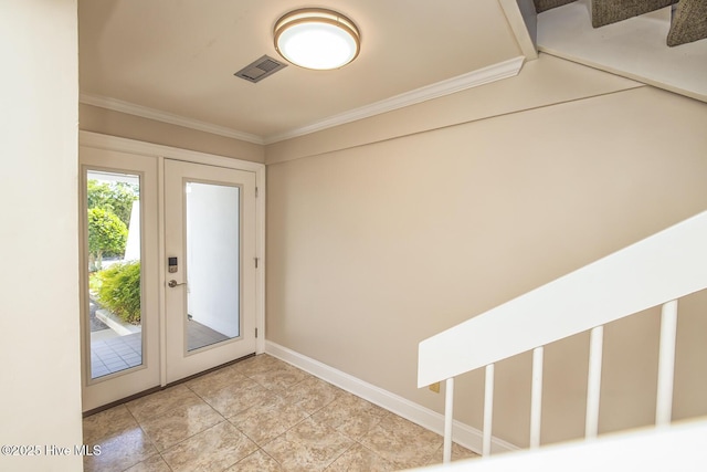 entryway with ornamental molding, light tile patterned floors, and baseboards