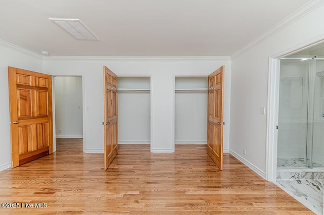 180 Frye Rd, Pinehurst, NC 28374 - unfurnished bedroom with two closets, light wood-type flooring, ornamental molding, connected bathroom, and baseboards