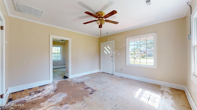 foyer with ceiling fan, crown molding, and baseboards