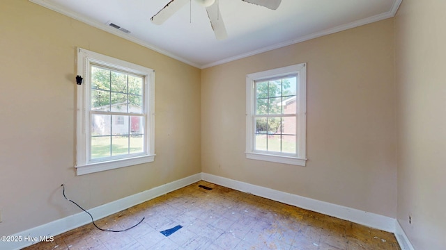 spare room featuring plenty of natural light, baseboards, ornamental molding, ceiling fan, and tile patterned floors
