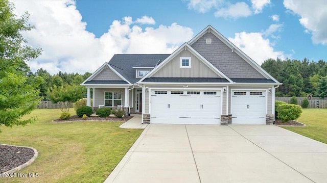 267 Brightleaf Dr, Whispering Pines, NC 28327 - craftsman-style house featuring a garage, concrete driveway, board and batten siding, stone siding, and roof with shingles
