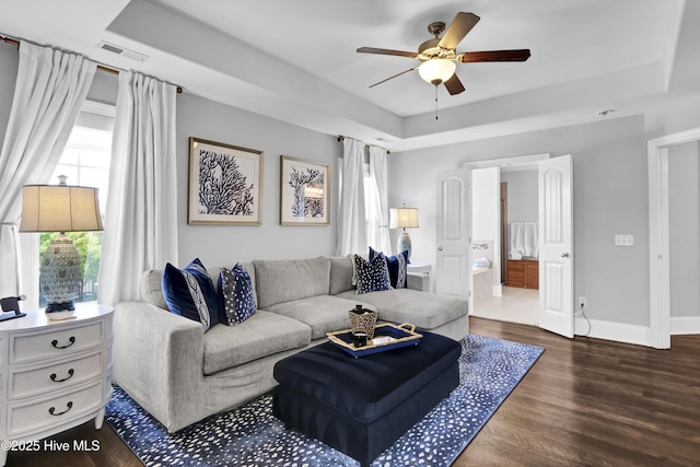 5606 Swiss Stone Ct, Wilmington, NC 28412 - living area with a tray ceiling, a ceiling fan, dark wood finished floors, and baseboards