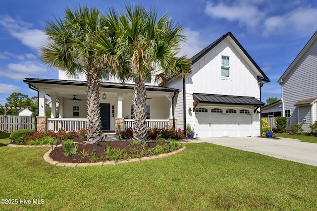 5606 Swiss Stone Ct, Wilmington, NC 28412 - view of front of home featuring a garage, covered porch, driveway, board and batten siding, and a standing seam roof