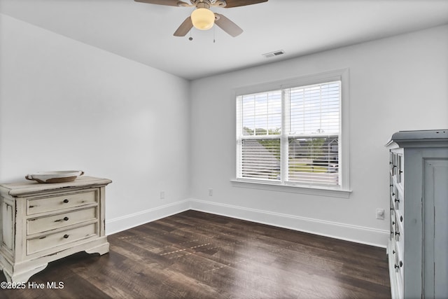 5606 Swiss Stone Ct, Wilmington, NC 28412 - unfurnished bedroom with dark wood-type flooring, baseboards, and a ceiling fan