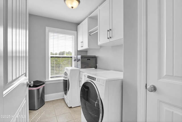 5606 Swiss Stone Ct, Wilmington, NC 28412 - laundry room with washing machine and dryer, cabinet space, baseboards, and light tile patterned floors