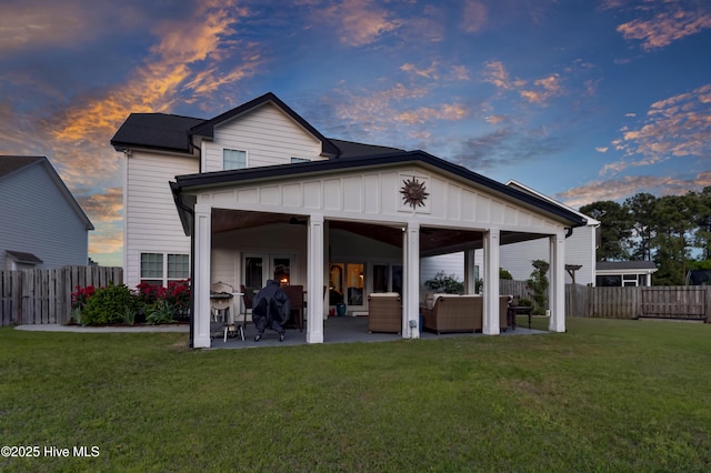 5606 Swiss Stone Ct, Wilmington, NC 28412 - back of house at dusk with outdoor lounge area, a patio, board and batten siding, and french doors