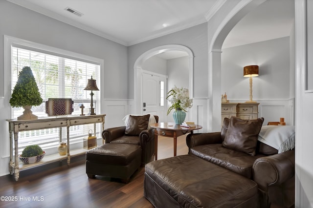 5606 Swiss Stone Ct, Wilmington, NC 28412 - sitting room with arched walkways, a decorative wall, dark wood-style flooring, crown molding, and a wainscoted wall