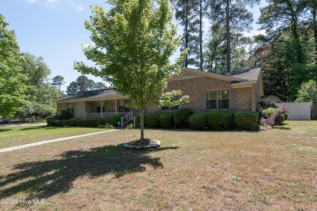 single story home featuring brick siding and covered porch