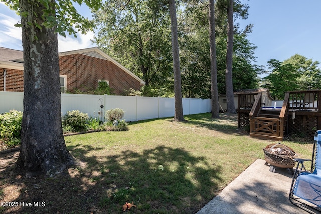 view of yard with a fire pit and a deck